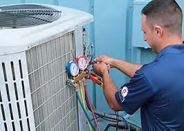 Technician checking refrigerant pressure at an outdoor air conditioning unit